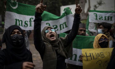 Indian Muslim woman shouts slogans during a protest in Delhi against the ban on Muslim girls wearing hijab in class.