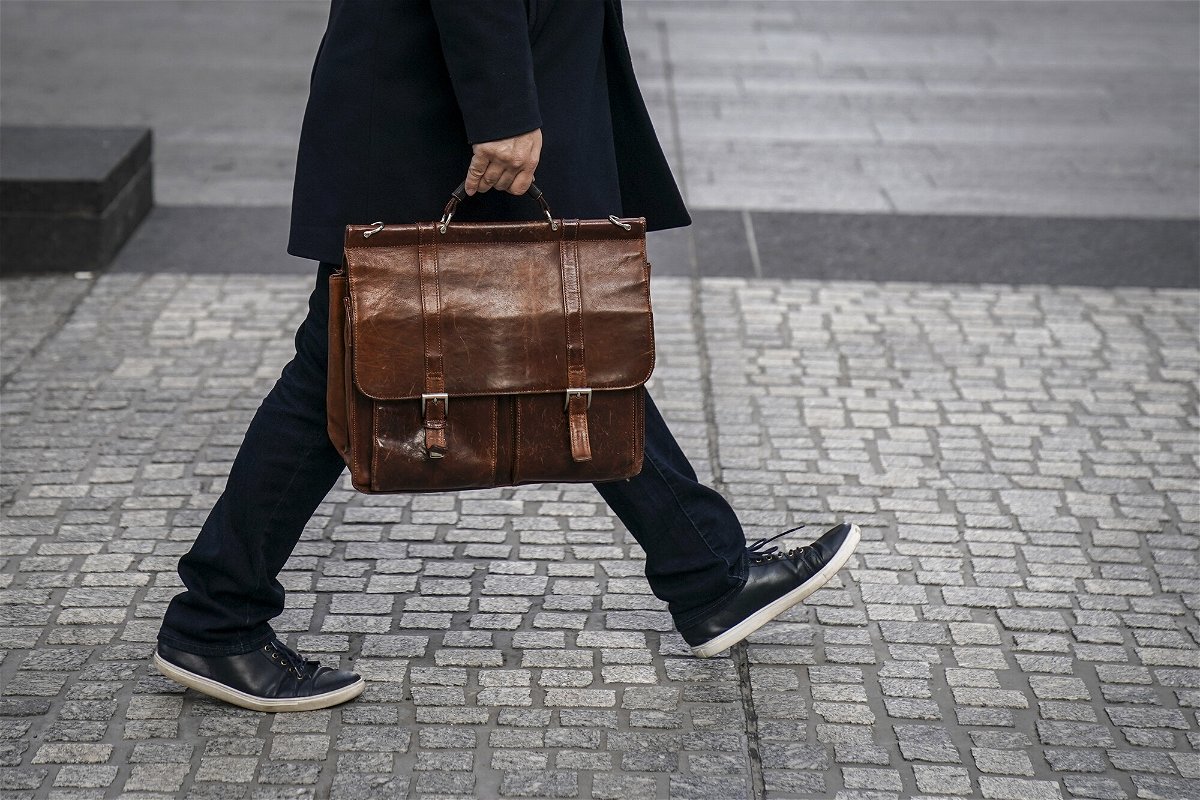 <i>Drew Angerer/Getty Images</i><br/>A man carries a briefcase as he walks through the Financial District