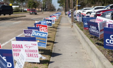 Campaign signs line the sidewalks on February 18