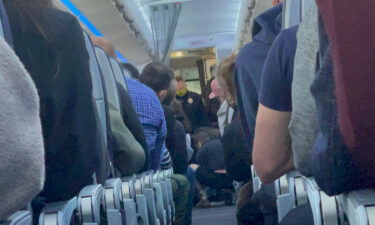 An eyewitness told CNN the passenger was trying to get into the cockpit and open the plane door.