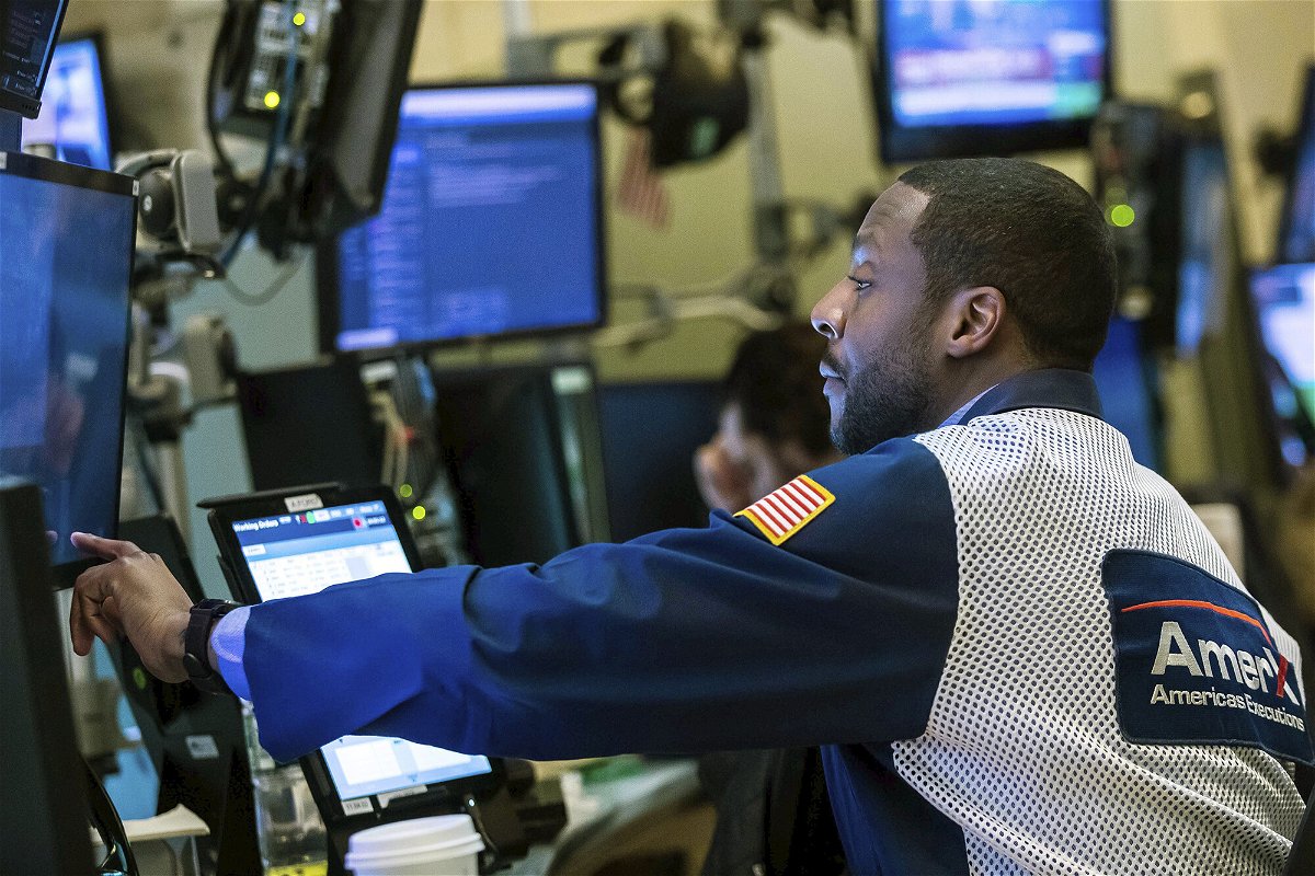 <i>Courtney Crow/New York Stock Exchange/AP</i><br/>Trader Aaron Ford works on the New York Stock Exchange floor