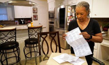 Pam Gaskin opens her mail ballot she received after multiple requests were rejected earlier this year at her home Monday