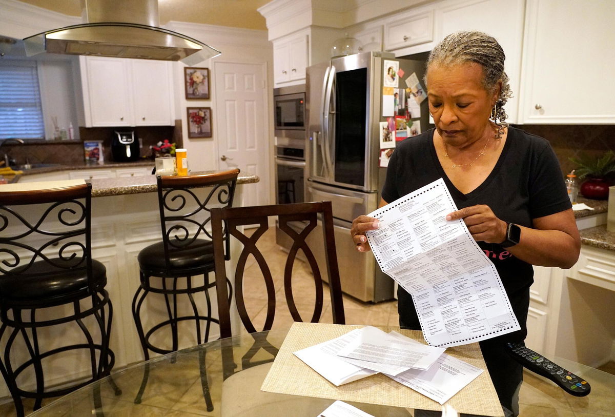 <i>Melissa Phillip/Houston Chronicle/AP</i><br/>Pam Gaskin opens her mail ballot she received after multiple requests were rejected earlier this year at her home Monday