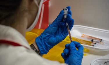 A nurse prepares syringes with the Pfizer coronavirus booster vaccination on January 20