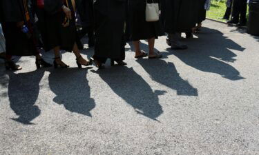 College graduates walk to their seats at their commencement ceremony in Manhattan in 2019.