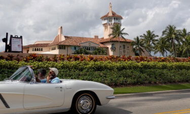 A car passes in front of former President Donald Trump's Mar-a-Lago resort on February 11 in Palm Beach