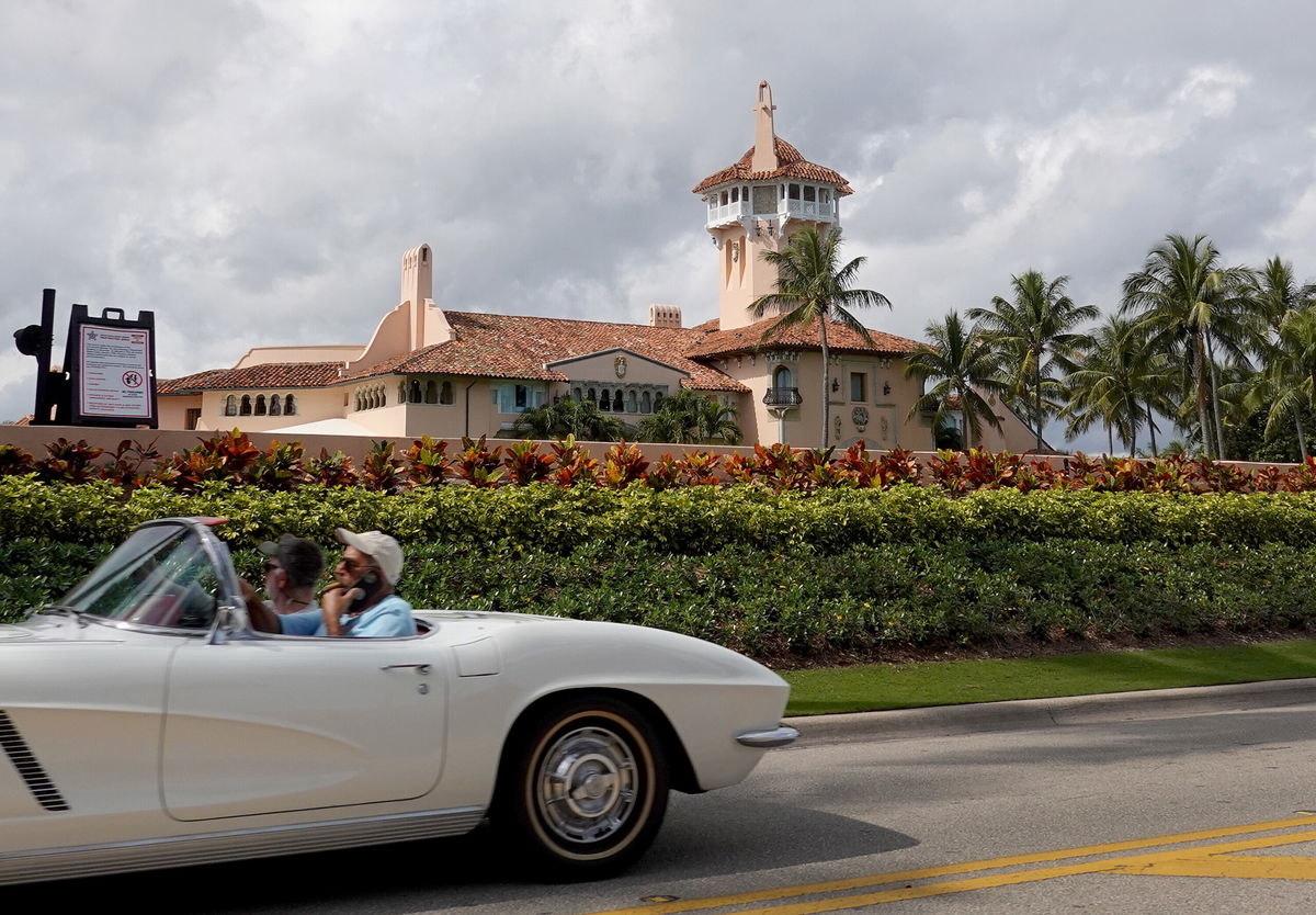 <i>Joe Raedle/Getty Images</i><br/>A car passes in front of former President Donald Trump's Mar-a-Lago resort on February 11 in Palm Beach