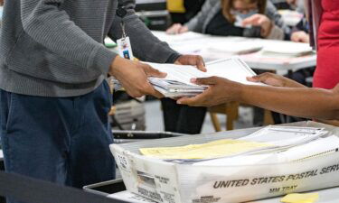 Gwinnett County election workers handle ballots as part of the recount for the 2020 presidential election at the Beauty P. Baldwin Voter Registrations and Elections Building on November 16