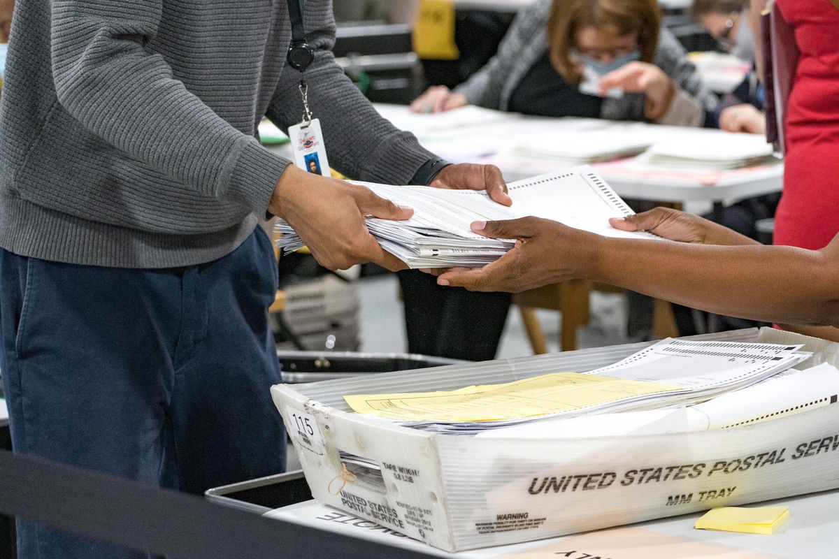 <i>Megan Varner/Getty Images</i><br/>Gwinnett County election workers handle ballots as part of the recount for the 2020 presidential election at the Beauty P. Baldwin Voter Registrations and Elections Building on November 16