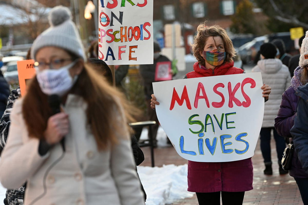 <i>Matt McClain/Washington Post/Getty Images</i><br/>People gather in support of continuing the school mask mandate outside the Loudon County Government Center prior to a Board of Supervisors meeting on January 18