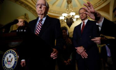 Senate Minority Leader Mitch McConnell (R-KY) talks to reporters with Sen. John Thune (R-SD) and other GOP leaders following the weekly Senate Republican policy luncheon at the U.S. Capitol on December 14