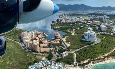 The flight comes in to land in Sint Maarten over Cupecoy Beach.