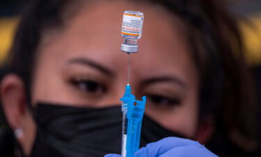 A healthcare worker prepares a dose of Pfizer-BioNTech Covid-19 vaccine at a vaccination site in San Francisco