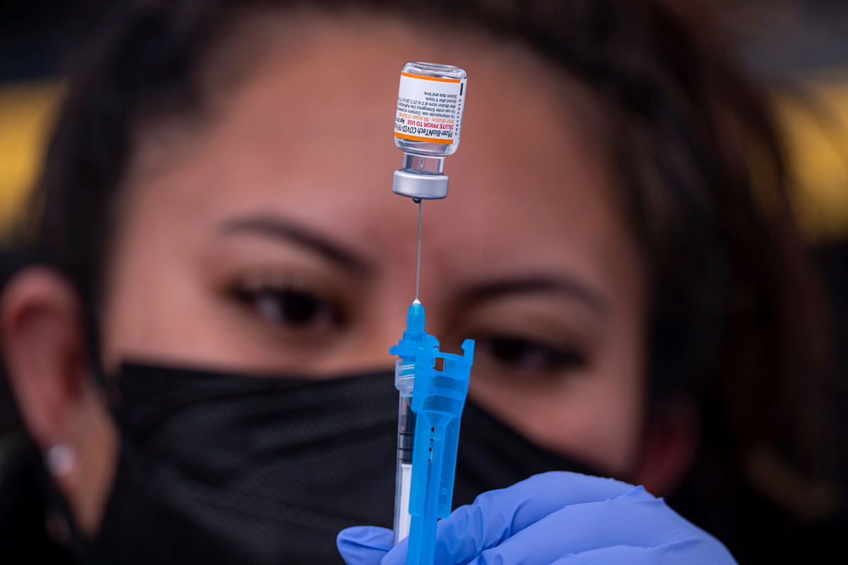 <i>David Paul Morris/Bloomberg/Getty Images</i><br/>A healthcare worker prepares a dose of Pfizer-BioNTech Covid-19 vaccine at a vaccination site in San Francisco