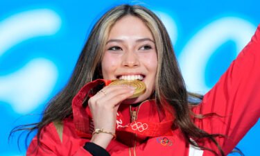 Gold medalist Eileen Gu of China celebrates during the medal ceremony for the women's freestyle skiing big air at the 2022 Winter Olympics.