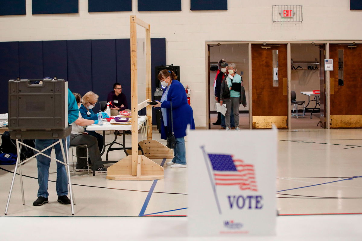 <i>Kamil Krzaczynski/AFP/Getty Images</i><br/>A woman checks in to cast her ballot during a Democratic presidential primary election at the Kenosha Bible Church gym in Kenosha