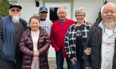 Nooksack tribal members who are facing evictions pose for a photo in front of Norma Aldredge's home. From left to right