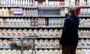 A shopper walks through the dairy aisle of a grocery store in Washington