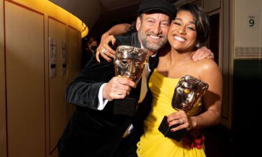 Actors Troy Kotsur and Ariana DeBose hold the BAFTAs they won for supporting roles on Sunday
