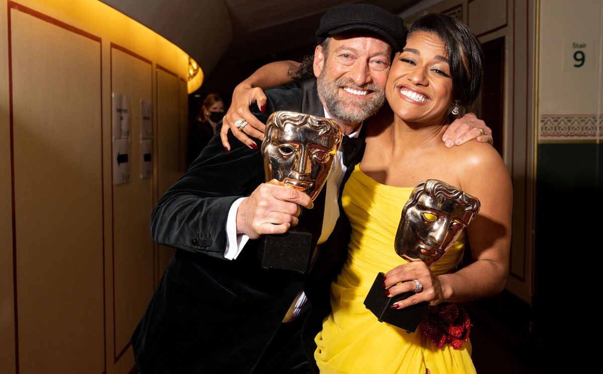 <i>Scott Garfitt/Shutterstock for BAFTA</i><br/>Actors Troy Kotsur and Ariana DeBose hold the BAFTAs they won for supporting roles on Sunday