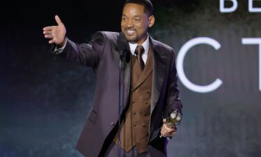 Will Smith accepts a best actor award for his role in the film "King Richard."