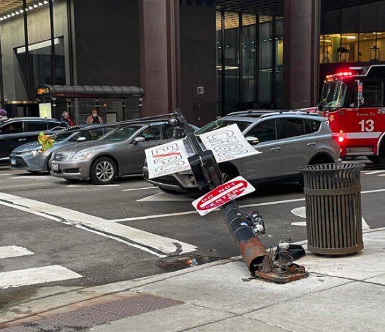<i>WBBM</i><br/>The base of the light pole was visibly rusted out as it lay on its side between two orange cones at Columbus Drive and Grand Avenue
