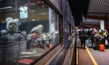 Ukrainian children travel aboard a train for refugee relocation on February 28