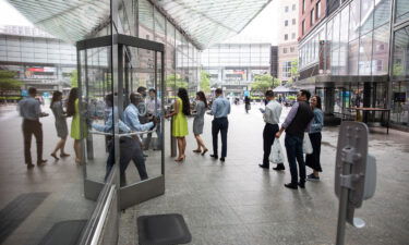 New York City office workers wait in line to enter Goldman Sachs headquarters in June 2021. The company has required Covid-19 vaccination for entry since August 24