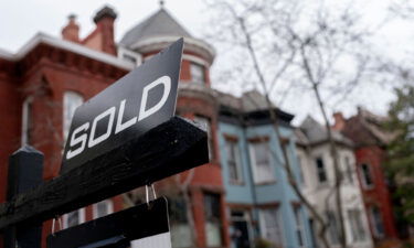 A sold sign is posted in front of a house in Washington