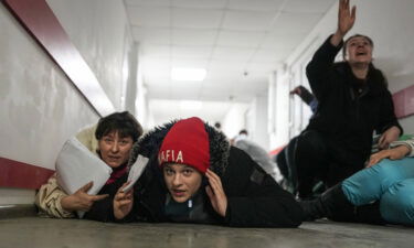 People lie on the floor of a hospital during shelling in the Ukrainian city of Mariupol on March 4.