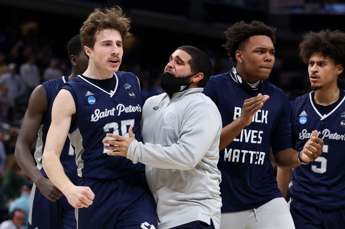 <i>Dylan Buell/Getty Images North America/Getty Images</i><br/>Saint Peter's Peacocks guard Doug Edert (L) celebrates after making a three-pointer against the Kentucky Wildcats on March 17. The Peacocks stunned the Wildcats during the first round of March Madness.