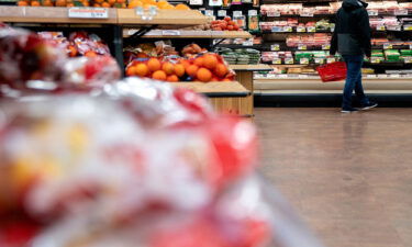 A shopper walks through a grocery store in Washington