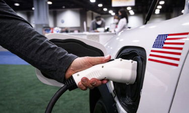 An exhibitor demonstrates Ford's electric Mustang during the Washington Auto Show in January.