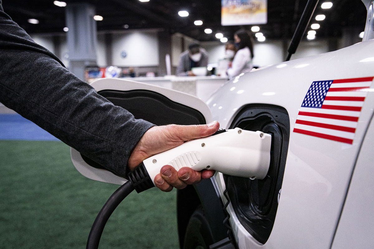 <i>Al Drago/Bloomberg/Getty Images</i><br/>An exhibitor demonstrates Ford's electric Mustang during the Washington Auto Show in January.