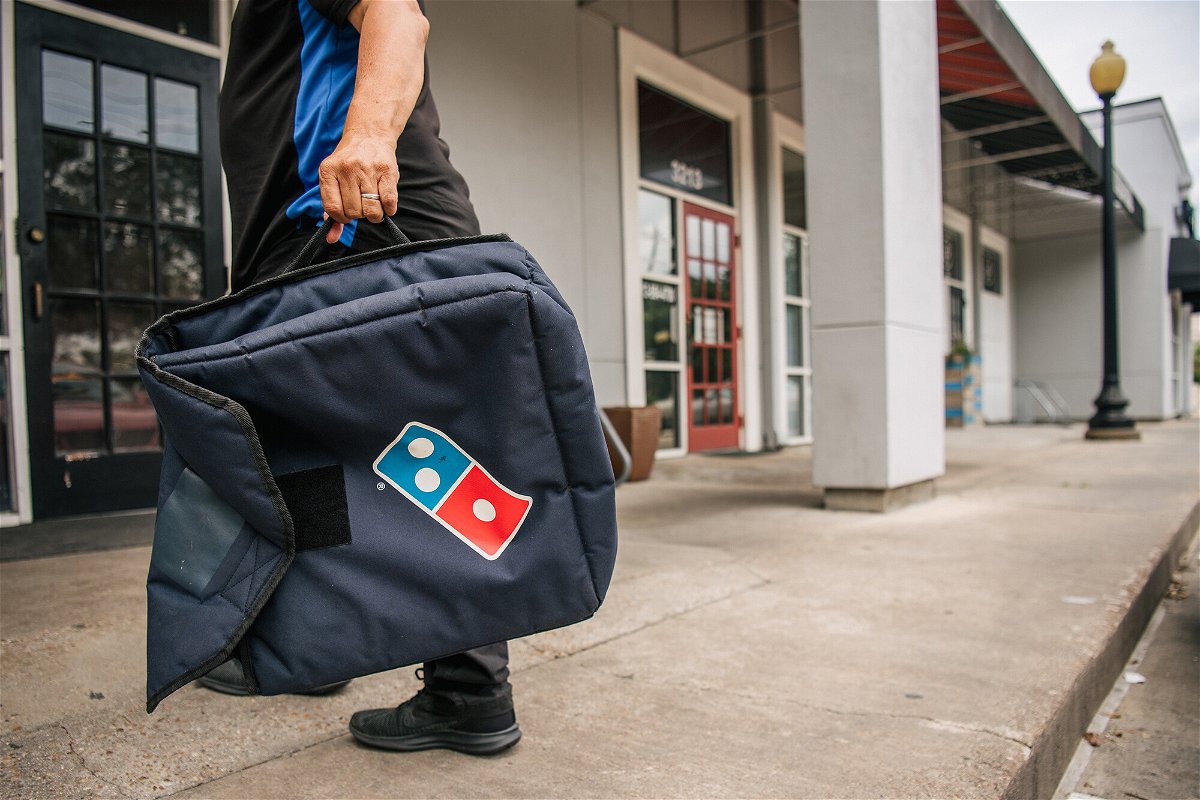 <i>Brandon Bell/Getty Images</i><br/>A Domino's Pizza employee returns from a delivery on July 22