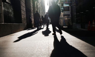 A Gallup survey released on March 18 reveals that 1 in 4 American workers feel their employers don't care about their well-being. Pictured are people walking along Wall Street on February 16 in New York City.
