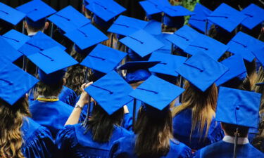 A celebration of graduation with a sea of blue graduation caps and robes. The Department of Education said March 9 that it has so far identified 100
