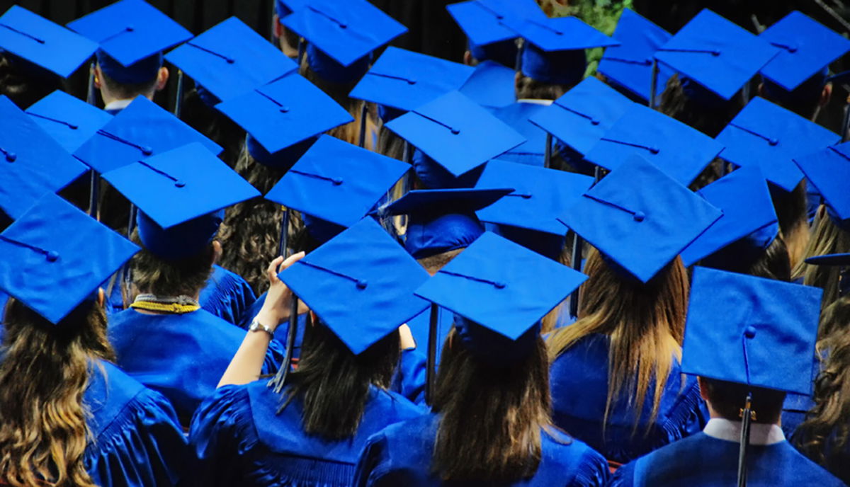 <i>Linda Goodhue Photography/Getty Images</i><br/>A celebration of graduation with a sea of blue graduation caps and robes. The Department of Education said March 9 that it has so far identified 100