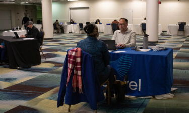 A representative conducts an interview during a job fair in Detroit