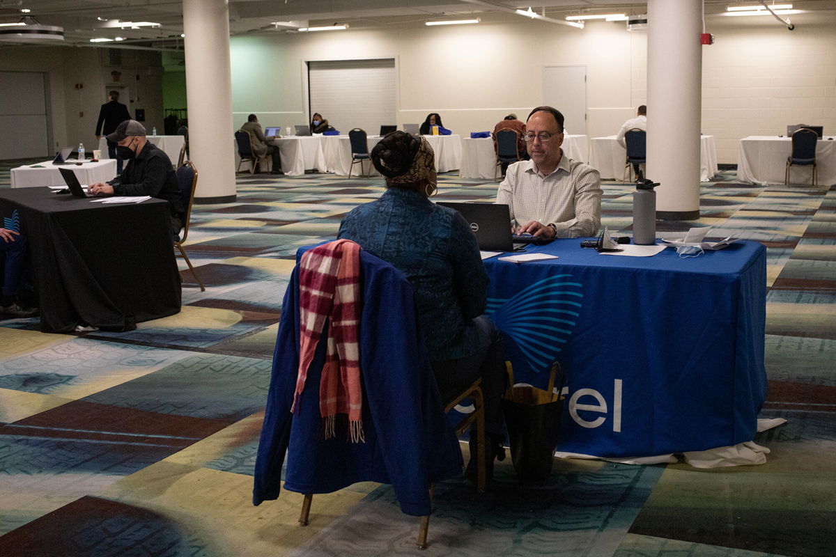 <i>Emily Elconin/Bloomberg via Getty Images</i><br/>A representative conducts an interview during a job fair in Detroit