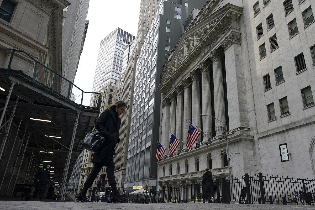 <i>Seth Wenig/AP</i><br/>Pedestrians walk past the New York Stock Exchange on Thursday