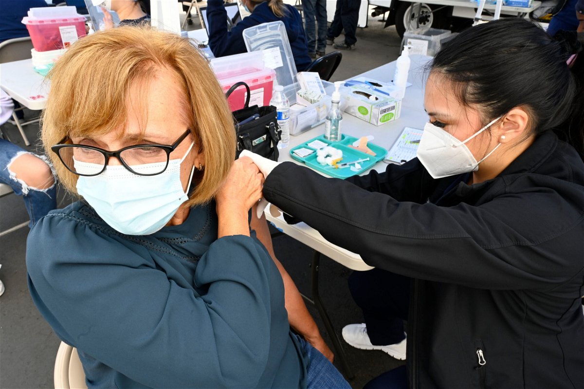 <i>Brittany Murray/MediaNews Group/Long Beach Press-Telegram/Getty Images</i><br/>Cathy Dozal (L) gets her second Covid-19 booster shot in Long Beach