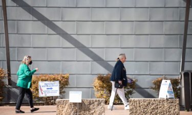 Voters walk into Lochwood Branch Library to participate in the Texas primary election in Dallas on Tuesday