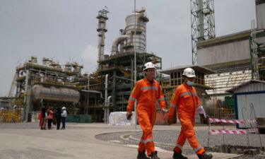 Workers walk past the newly inaugurated Dangote fertilizer plant in Lagos