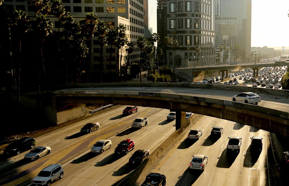 <i>Luis Sinco/Los Angeles Times/Getty Images</i><br/>Traffic slows on the Harbor Freeway in downtown Los Angeles in November 2021. The EPA announced Wednesday that it would allow California to adopt stricter vehicle emissions standards than the federal rules.