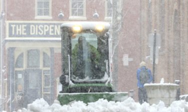 A city worker plows the sidewalk near Lancaster's Central Market Saturday in Lancaster