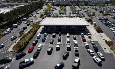 People wait in their vehicles in line to buy gas at a Costco in San Marcos