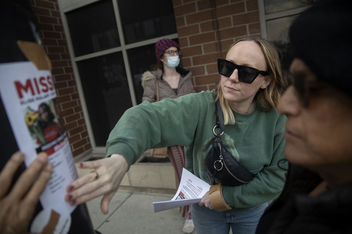 <i>Erin Hooley/Chicago Tribune/Getty Images</i><br/>Lindsay Doyle and Alexis Martinez post fliers for missing activist Elise Malary on March 17. The body of a woman found in Lake Michigan on March 17 has been identified as missing transgender rights advocate Elise Malary