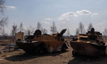 Two destroyed Russian armored personnel carriers are seen on March 25 in Kyiv.