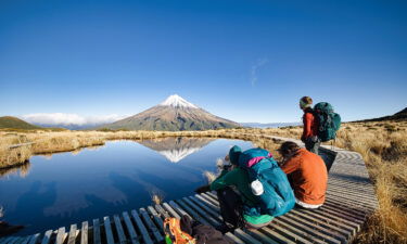 Tourists enjoy the view of Mount Taranaki in New Zealand
